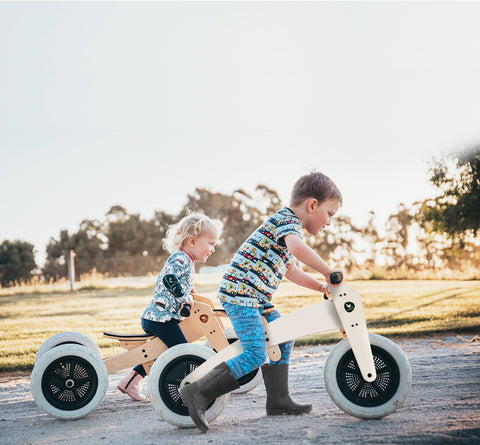 Two kids using their eco-friendly bikes in a park