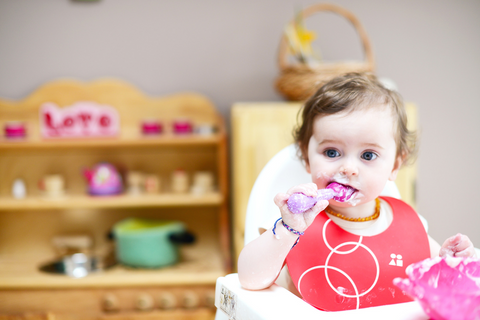 Baby chewing on silicone baby spoon